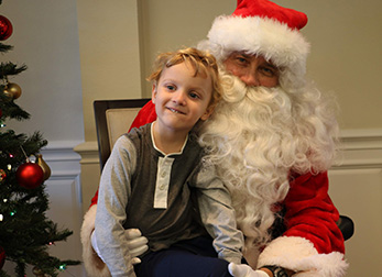 Santa and boy at Cookies with Santa event