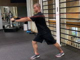 trainer performing power training move with resistance band