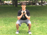 trainer squatting with dumbbell