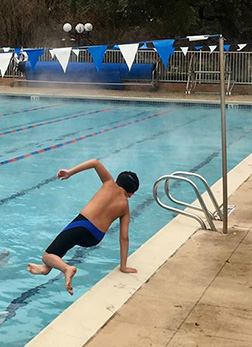 Polar Bear swim training student jumping into the CFC pool
