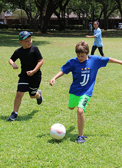 Boys playing soccer at summer camp