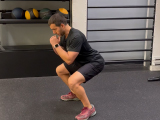 Trainer demonstrating a body weight squat.