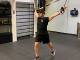 Trainer demonstrating stretches using TRX straps