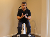Trainer performing a squat on the Power Plate